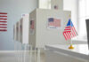 Voting booths with American flags in a polling station