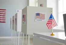 Voting booths with American flags in a polling station