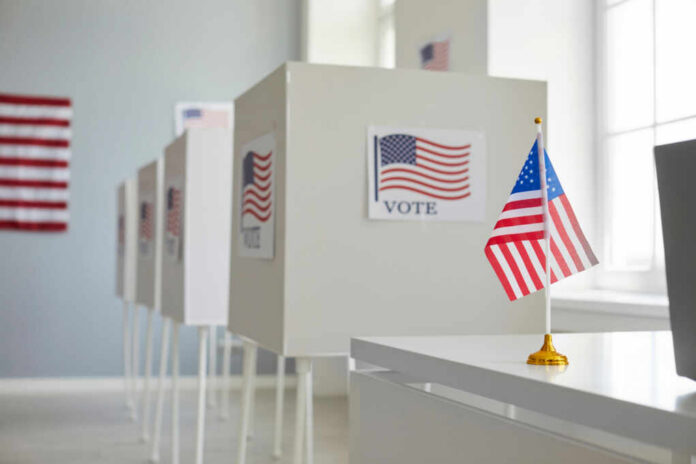 Voting booths with American flags in a polling station