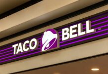 Taco Bell Faces Parasite Outbreak Questions Taco Bell storefront sign with purple bell logo