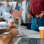 Will Senate Block SAVE America? People participating in a voting event with American flags and paperwork
