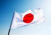 New Japan Law Raises Free Speech Fears Japanese flag with a red circle on a white background waving against a blue sky
