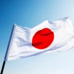 New Japan Law Raises Free Speech Fears Japanese flag with a red circle on a white background waving against a blue sky