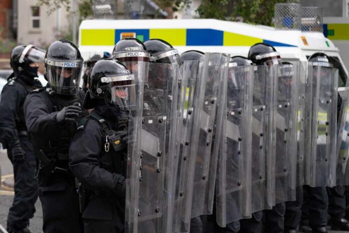 Belfast,-,Northern,Ireland,August,3,2024,Psni,Wall,Pushing Riot police in formation with shields preparing for crowd control