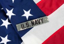 Close-up of an American flag with a U.S. Navy insignia