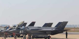 F-35 Fight Divides Trump And Netanyahu F-35 military jets parked on an airfield with crew members nearby