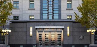 New Embassy Deal Faces Land Claims Entrance of the United States Embassy with modern architecture