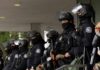 World Cup Sweep Uncovers Chilling Surprise A line of law enforcement officers in riot gear standing ready