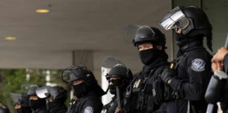 World Cup Sweep Uncovers Chilling Surprise A line of law enforcement officers in riot gear standing ready