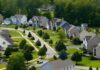 Bipartisan Housing Law Slips Past Trump A gavel and a model house with scales of justice in the background