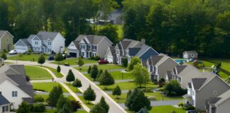 Bipartisan Housing Law Slips Past Trump A gavel and a model house with scales of justice in the background