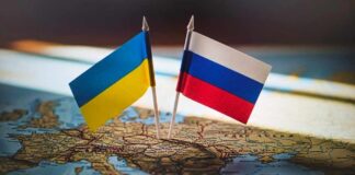 Ukrainian and Russian flags pinned on a map of Eastern Europe