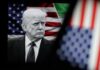 Trump: Iran Will Keep Paying Donald Trump in front of an American flag, displaying a serious expression