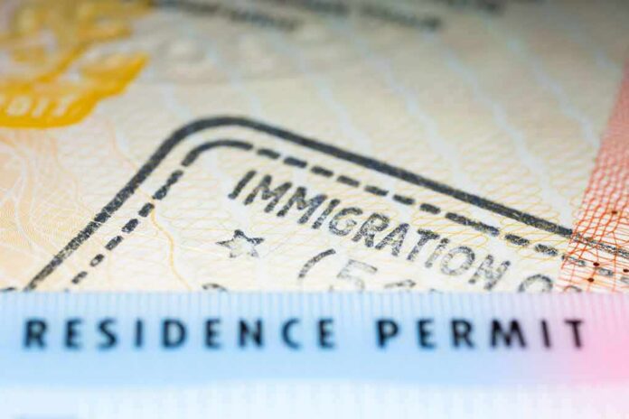 shutterstock_645219262 Residence permit document with immigration stamp