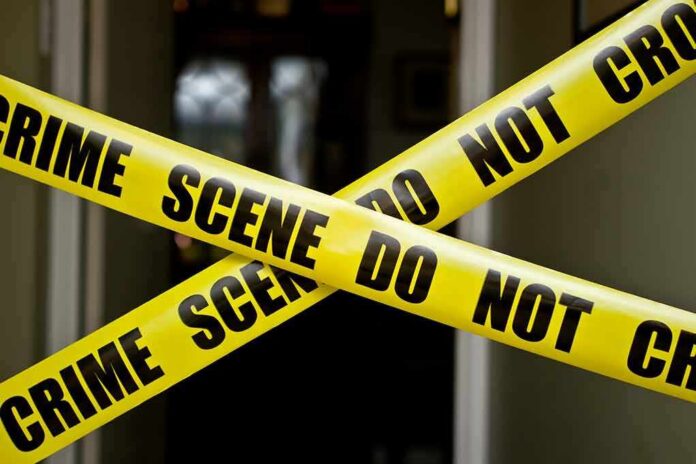 Yellow crime scene tape crossing a doorway