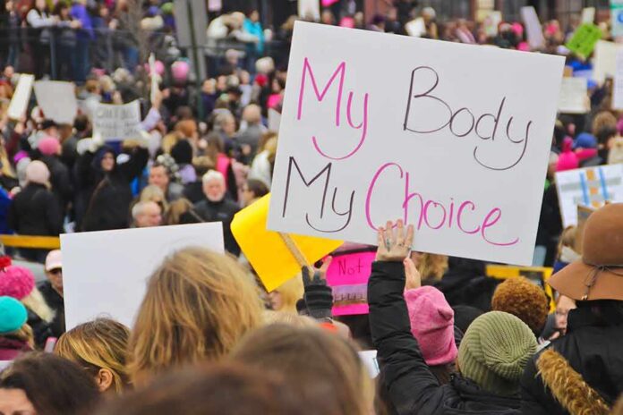 Protesters hold signs at a crowded march