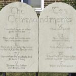 Nine–Eight Ruling Ignites Religion Fight Stone tablets of the Ten Commandments outside a building
