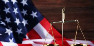 Massive Medicaid Grift Erupts In Pennsylvania golden balance scale in front of an American flag