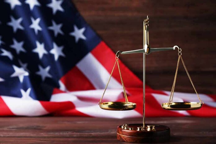 shutterstock_1079617001 golden balance scale in front of an American flag