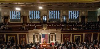 Supreme Court Twist Fuels Redistricting Fury Legislators gather on a chamber floor beneath a large flag