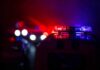 Police car light bar flashing red and blue at night