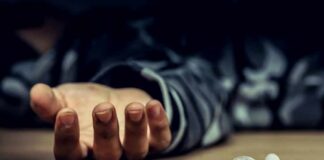 Overdose Rules NYC Homeless Deaths Syringe on table near an outstretched hand