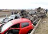 Overturned truck and damaged cars after highway crash