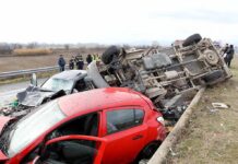 Overturned truck and damaged cars after highway crash