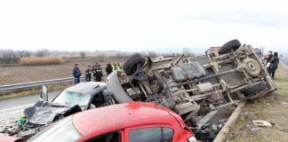 Overturned truck and damaged cars after highway crash