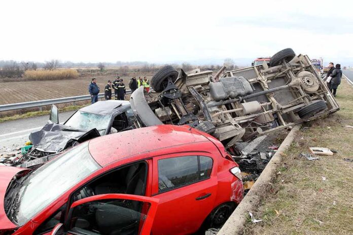 Overturned truck and damaged cars after highway crash