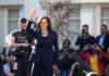 woman in navy suit waving at outdoor event