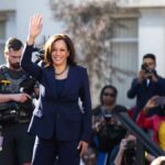 Inside Kamala Harris’s $8 Million Mansion woman in navy suit waving at outdoor event