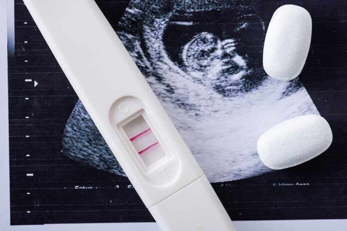 Pregnancy test with two lines on an ultrasound print