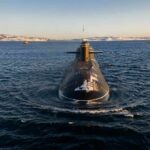 Submarine cruising on cold open water toward camera