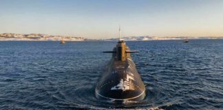 Submarine cruising on cold open water toward camera