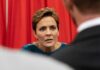 Solo GOP Block Shocks Trump Agenda Woman in teal dress listening intently