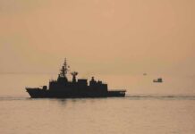 naval ship silhouette at sea during sunset