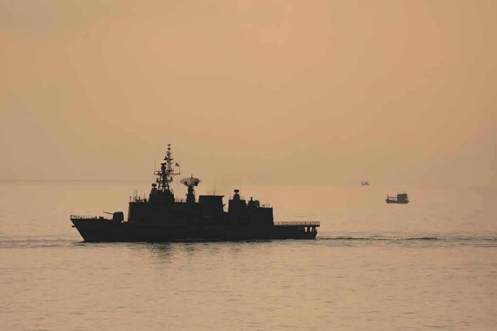 naval ship silhouette at sea during sunset