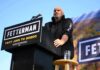 Unlikely Alliance Rattles Party Bosses Speaker at outdoor rally standing at podium with microphone