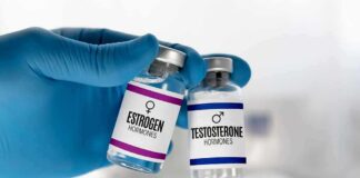 Nationwide Block: Puberty Drugs Defunded Gloved hand holding estrogen and testosterone vials
