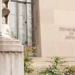 Trump Targets Fraudulent U.S. Citizenship Department of Justice building facade with stone sign and window