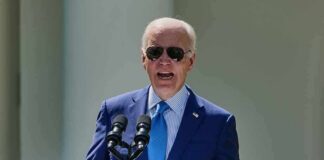 Painful Turn For Biden Stuns Allies man in blue suit speaking at a podium with presidential seal