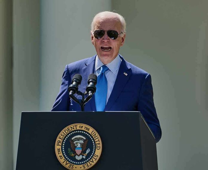 shutterstock_2299761835 man in blue suit speaking at a podium with presidential seal