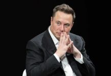 GOP Ground Game Supercharged By Musk man in a suit with hands clasped thoughtfully