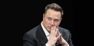 GOP Ground Game Supercharged By Musk man in a suit with hands clasped thoughtfully
