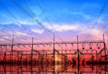 Electrical substation with power lines at sunset