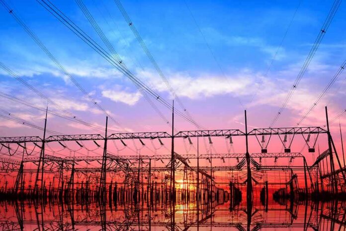 Electrical substation with power lines at sunset