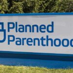 Funding Shortfall Forces Clinic Closures Planned Parenthood outdoor sign with blue logo