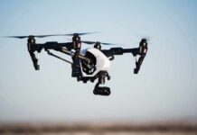 Quadcopter drone with camera flying outdoors