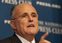 Giuliani Takes Aim At Islam On-Air man in suit speaking at a press event